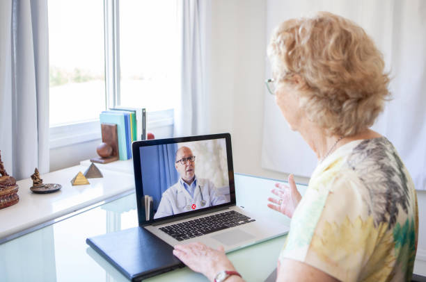 telehealth and palliative care patient at home talking with her doctor about her health by telehealth video conference.
